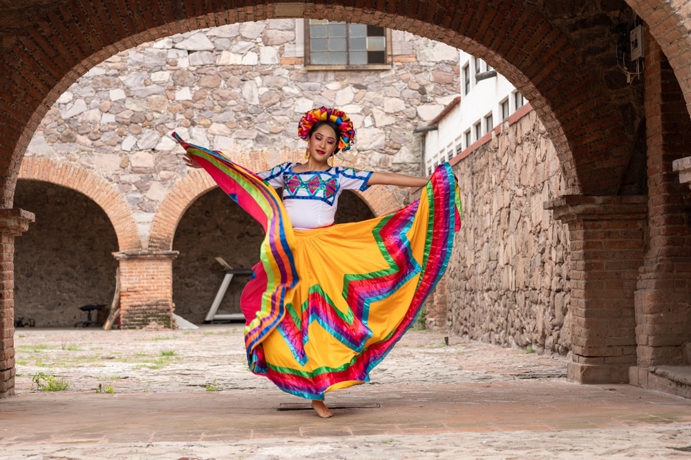 A view of a girl wearing a mexican suit dancing