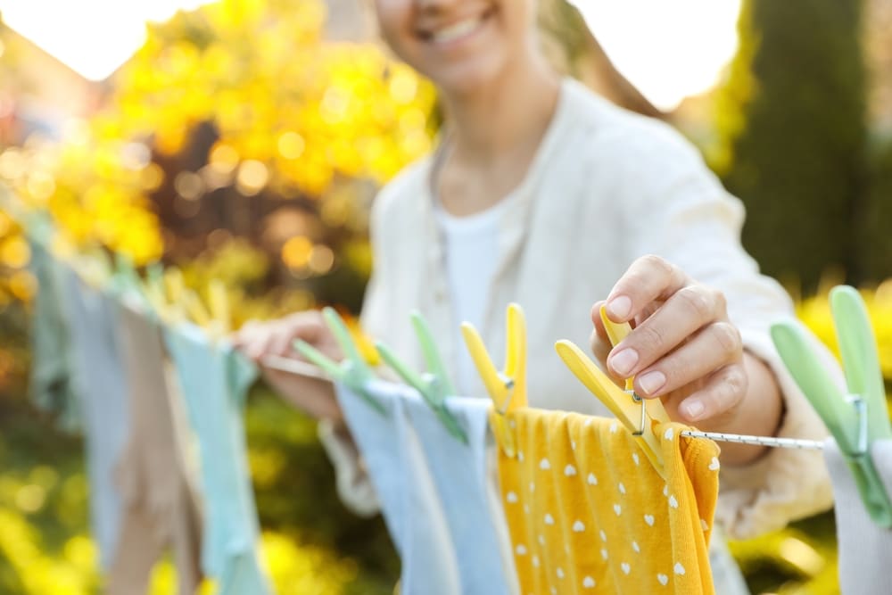 A view of a lady drying clothes on a clothesline