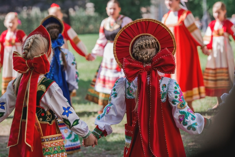 A view of of people dancing around wearing russian dresses