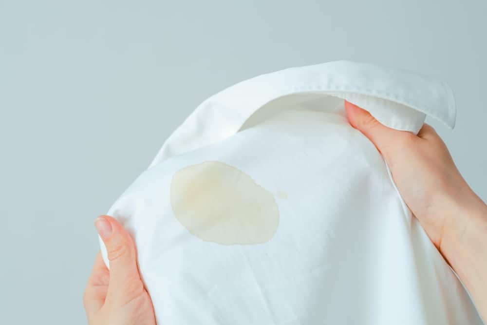 A white shirt with an oil stain on it