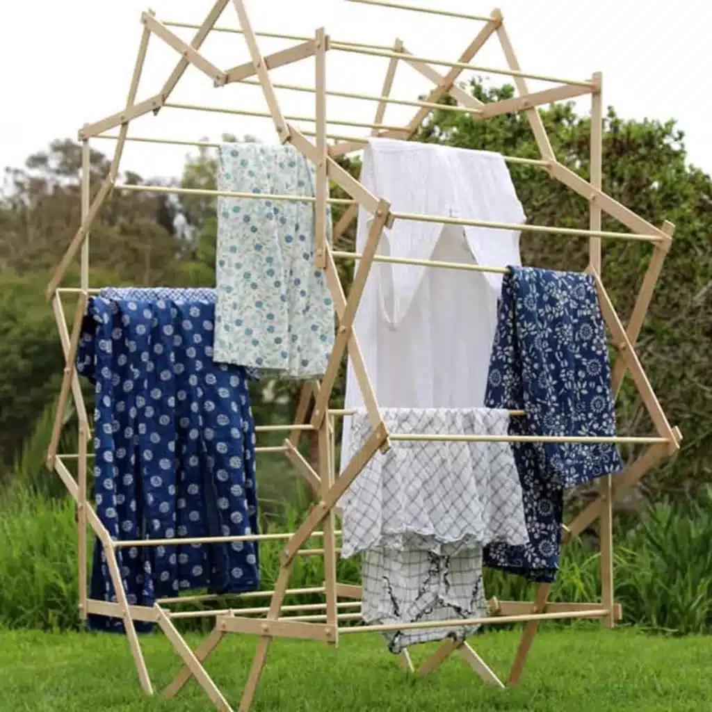 A star shaped rack with clothes hanging to dry outdoors