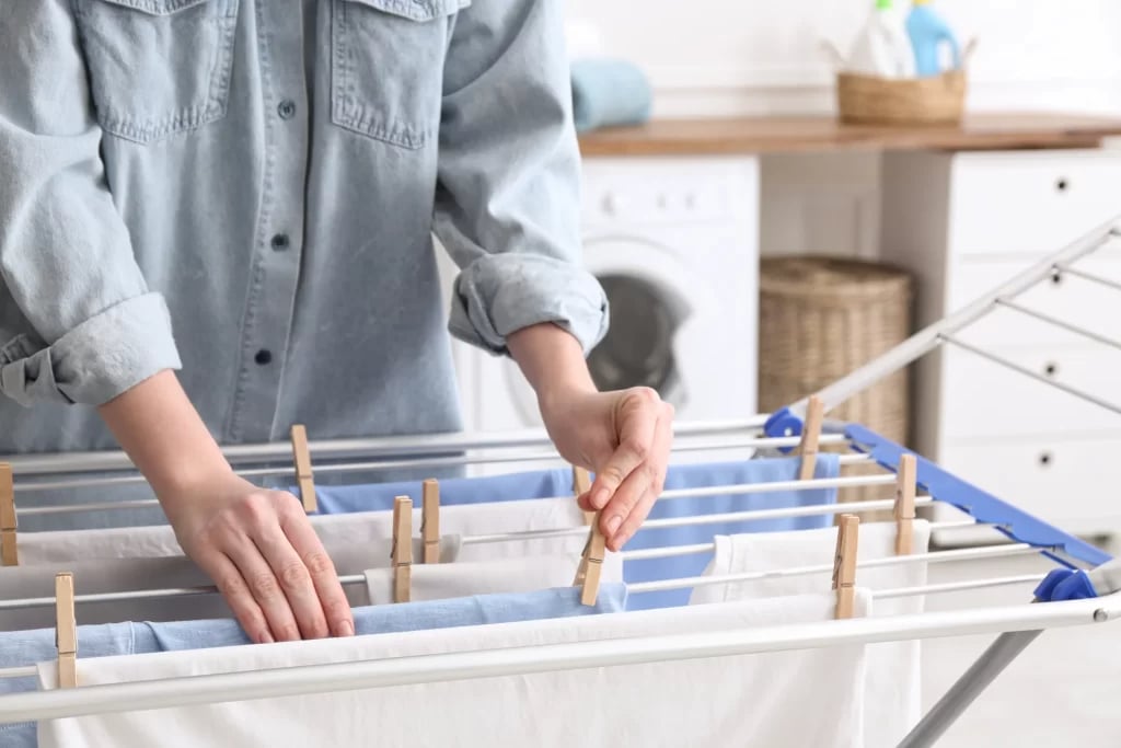 a person setting clothes to hang