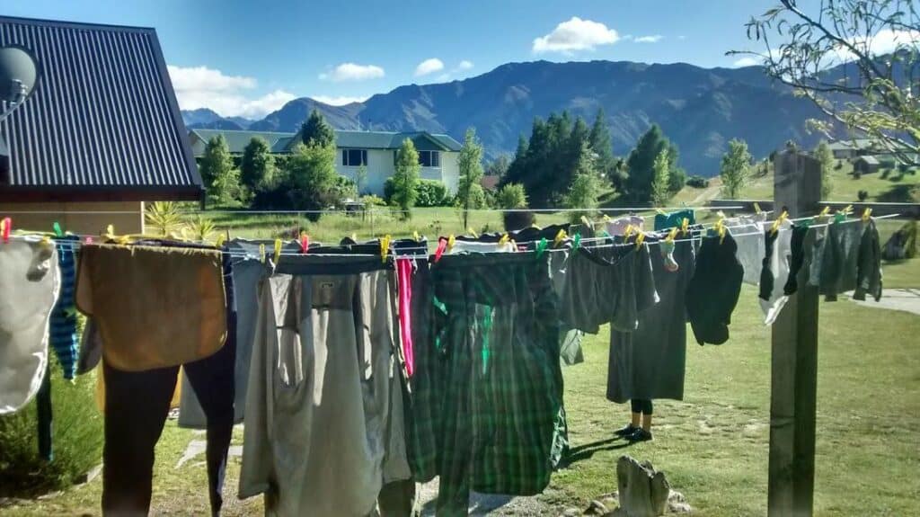 different clothes hung on clothes line in the outdoor space infront of mountains