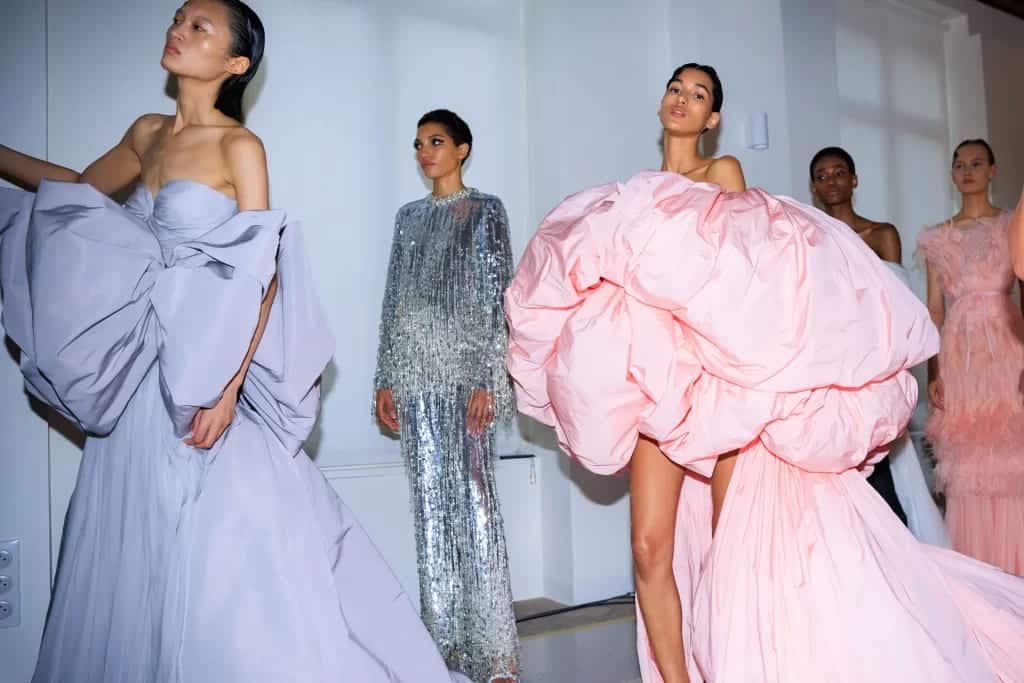 ladies wearing exquisite haute couture gowns in lavendar pink and silver color