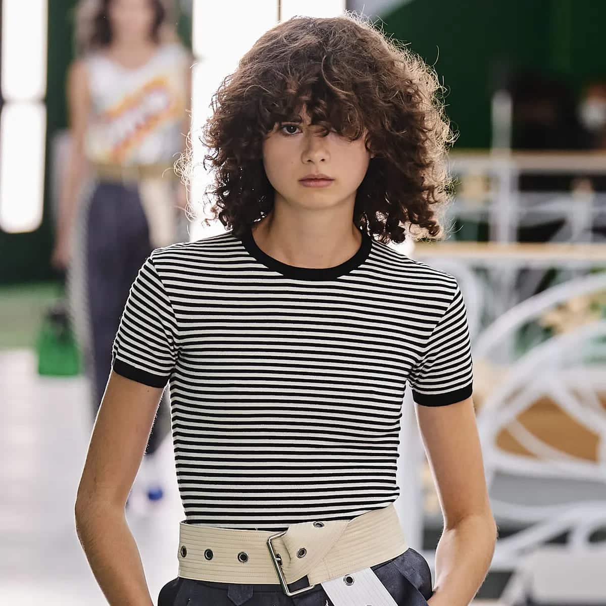 lady styling black and white stripes shirt standing