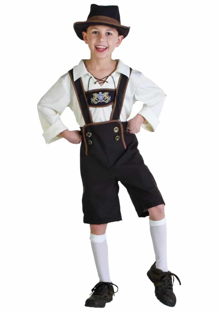 small boy wearing hat and lederhosen in black and white color