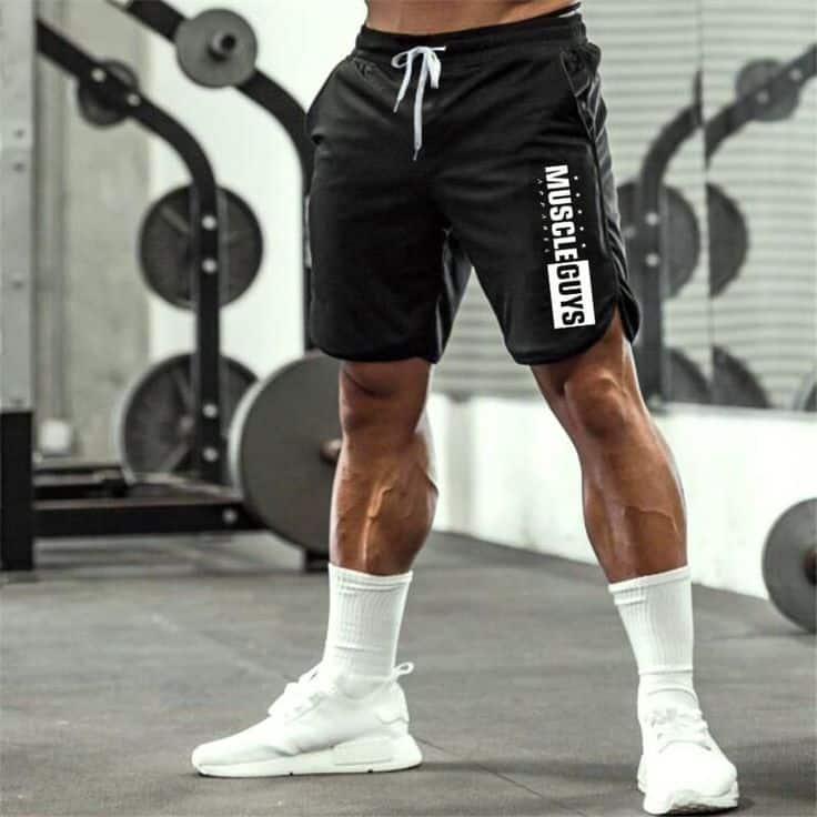 A lower view of a guy wearing gym shorts