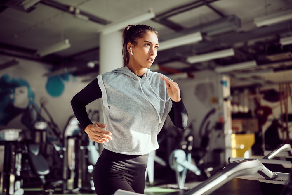 A view of a girl running on a gym treadmill