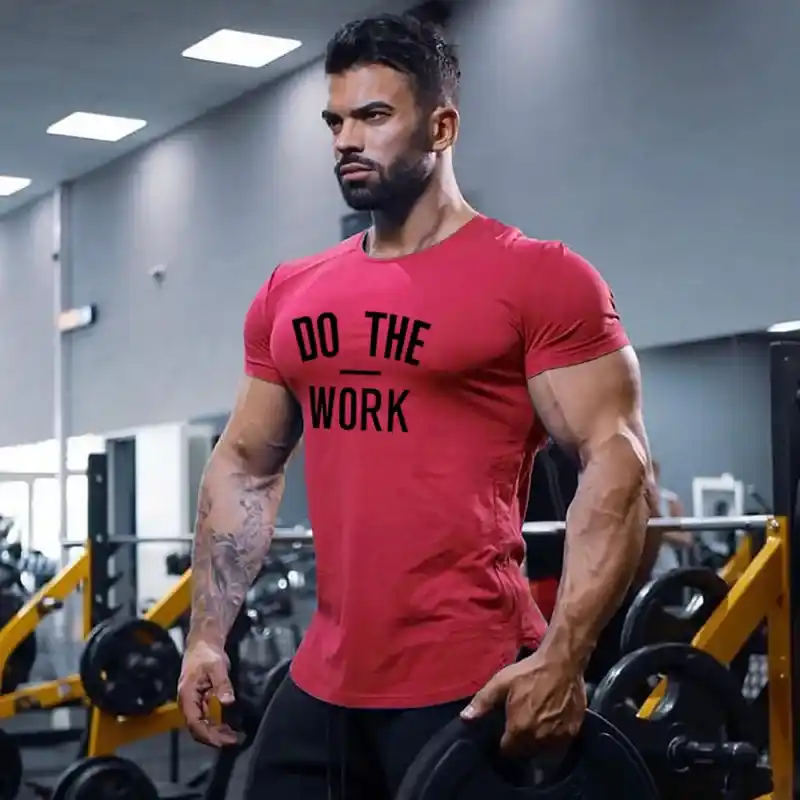 A view of a muscular guy in gym wearing a red cotton shirt