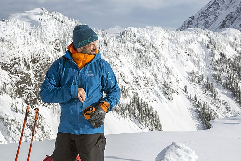 A view of a person wearing a blue shell jacket in snow