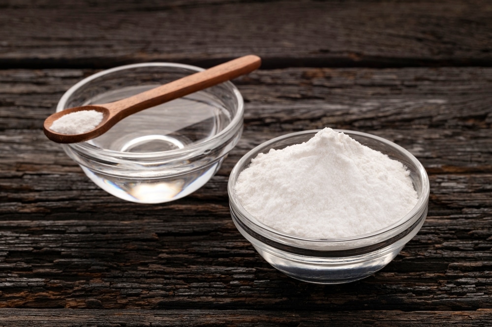 Baking soda powder and mineral water in bowls