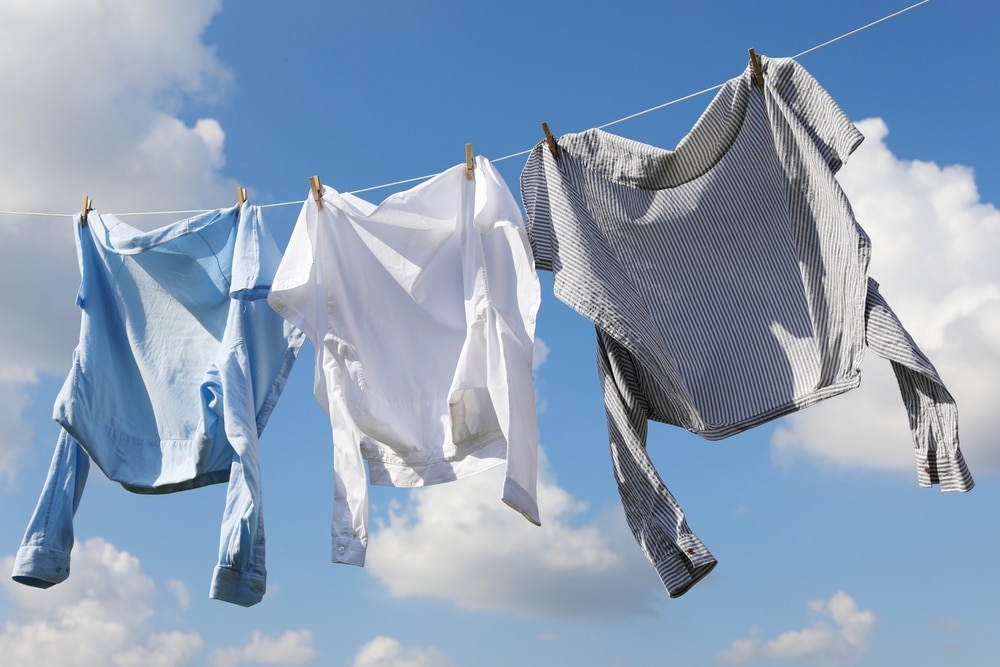 Clean Clothes Hanging On Washing Line Against Sky 