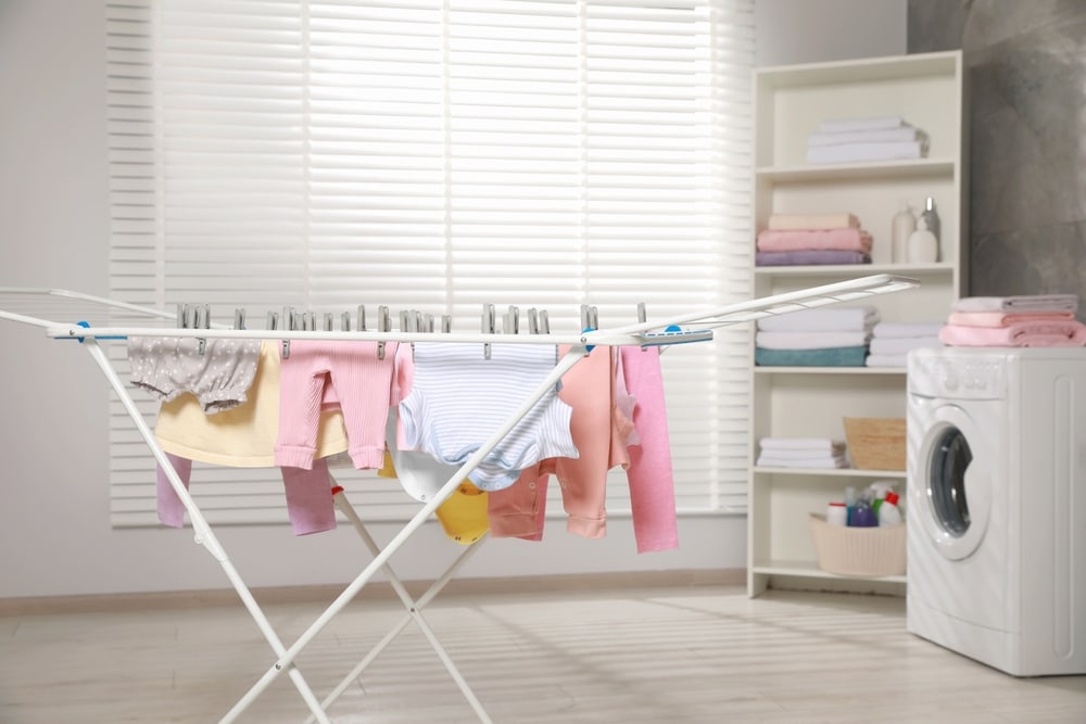 Clean Laundry Hanging On Drying Rack Indoors