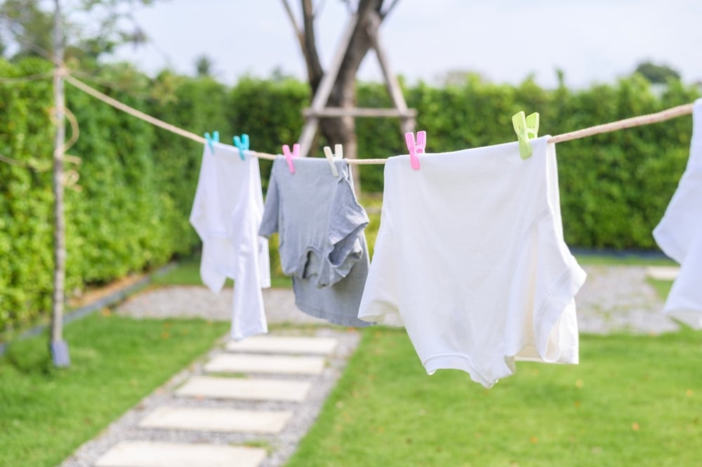 Clothes Hanging Laundry On Washing Line For Drying Against Blue