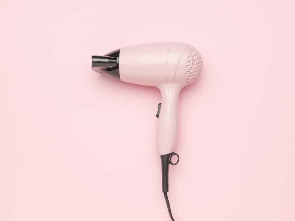 Minimalist Pink Hair Dryer On Pastel Pink Background 