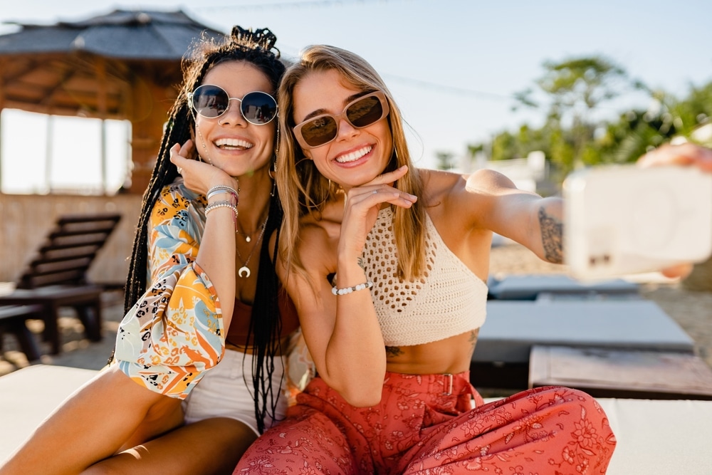 Stylish Smiling Beautiful Women Relaxing Having Fun On Beach In