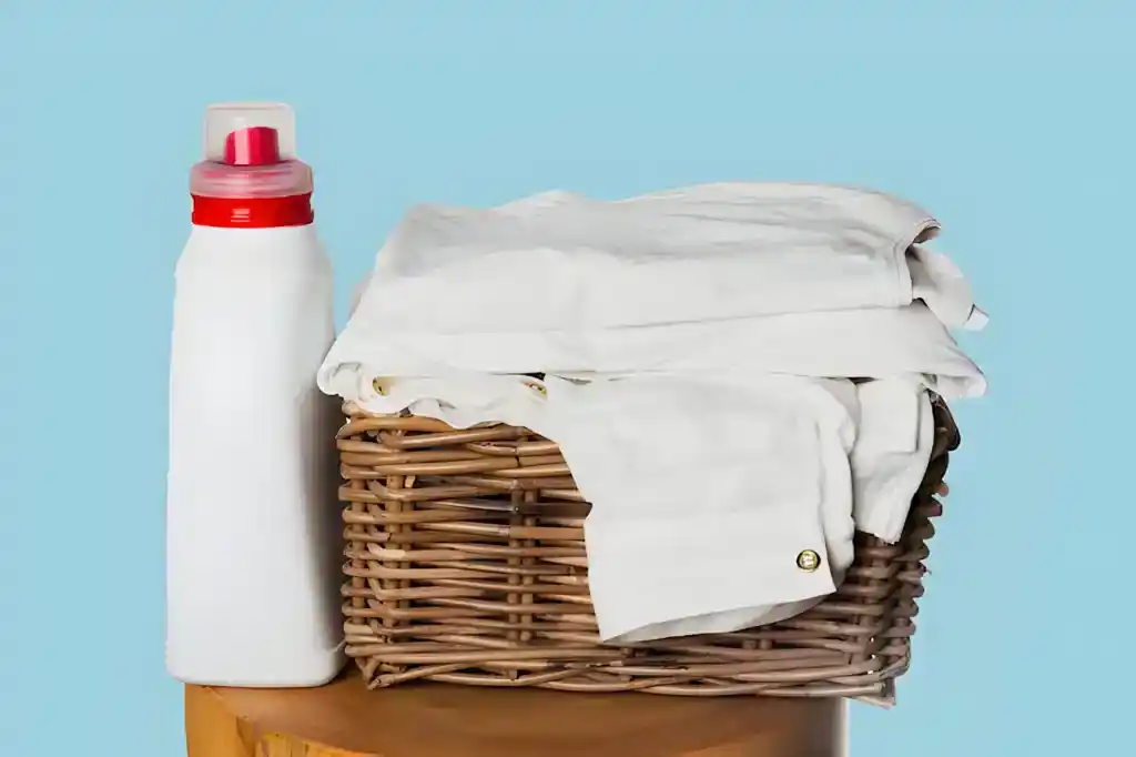 bottle of bleach with bucket of white clothes