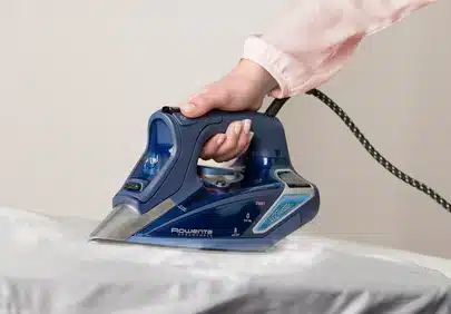 a women holding 1.Rowenta DW9280 Steam Force Iron