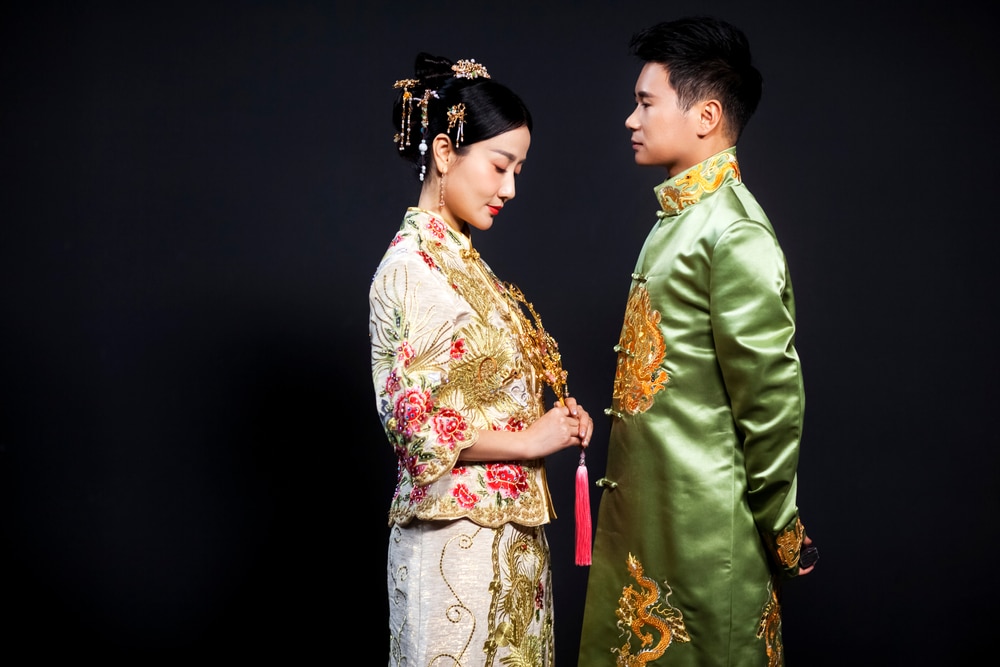 A view of a couple wearing a Tang suit