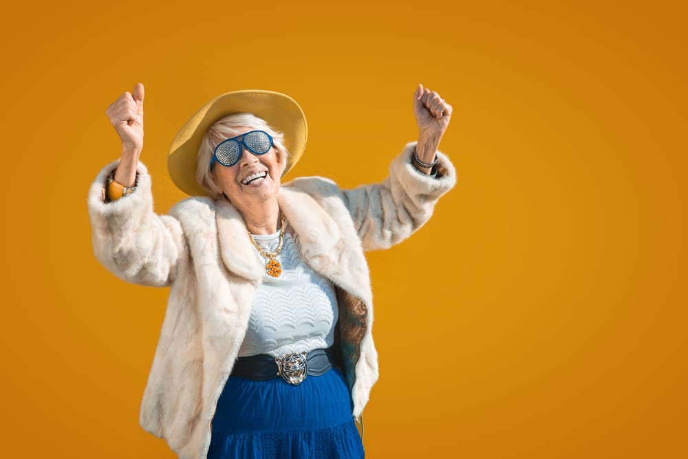 A view of an old lady dancing wearing stylish clothes